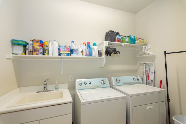 laundry room with separate washer and dryer and sink