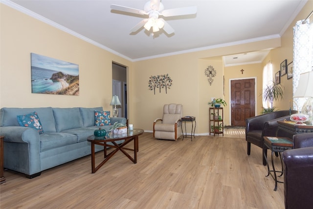 living room featuring ceiling fan, light wood-type flooring, and ornamental molding