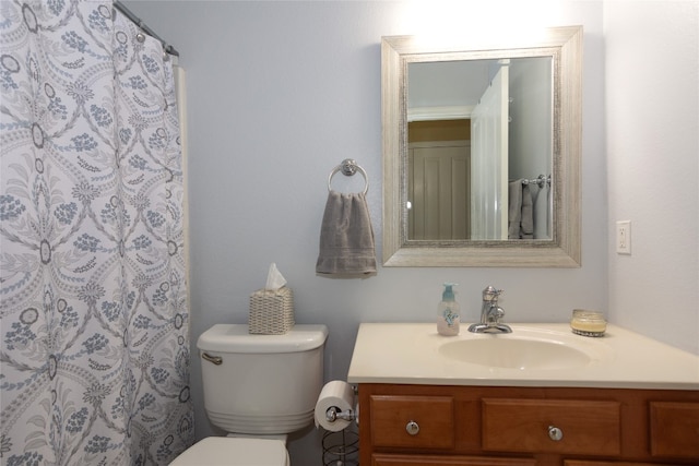 bathroom featuring curtained shower, vanity, and toilet