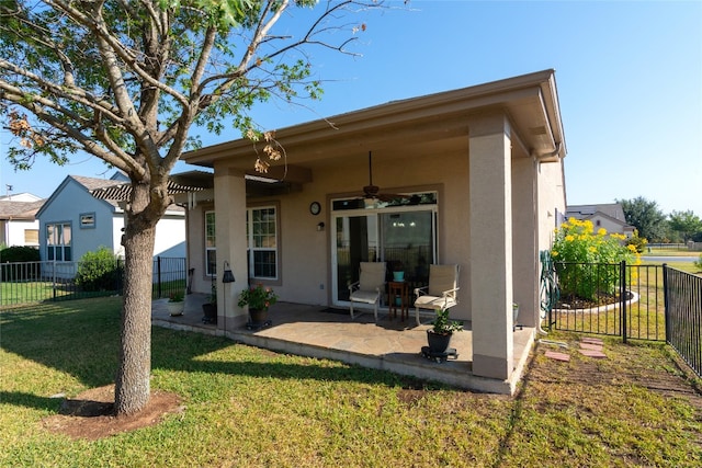 back of property featuring a patio area, ceiling fan, and a yard