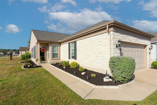 view of property exterior featuring a garage and a lawn