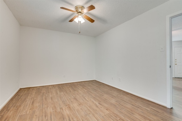 empty room with ceiling fan, a textured ceiling, and light hardwood / wood-style flooring