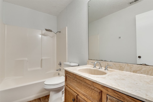 full bathroom featuring vanity, toilet, a textured ceiling, bathing tub / shower combination, and hardwood / wood-style floors