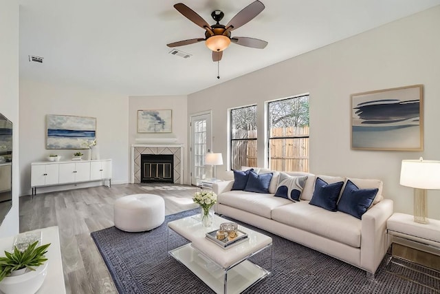 109 W Mockingbird Ln Unit A2, Austin, TX 78745 - living room featuring wood finished floors, ceiling fan, and a fireplace
