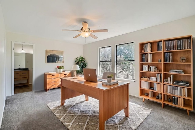 home office with a ceiling fan and light colored carpet