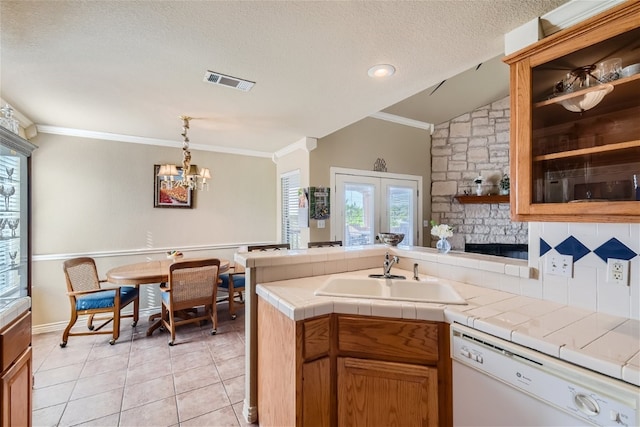 kitchen with tile counters, sink, white dishwasher, light tile patterned floors, and crown molding