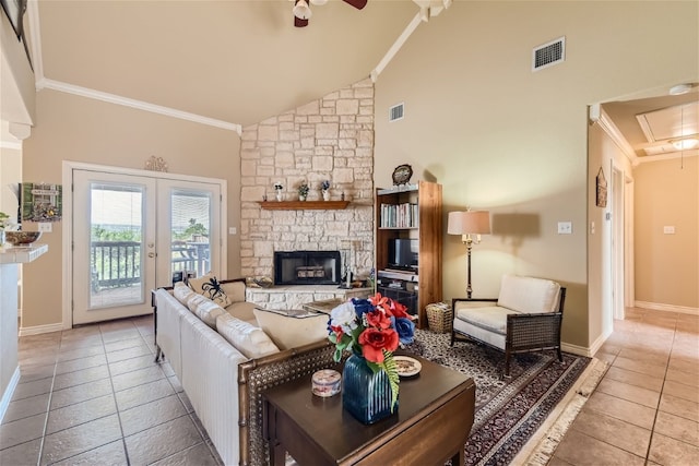 living room with tile patterned floors, high vaulted ceiling, crown molding, and a stone fireplace