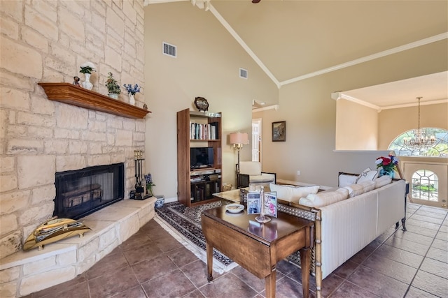 tiled living room with high vaulted ceiling, crown molding, a stone fireplace, and a notable chandelier