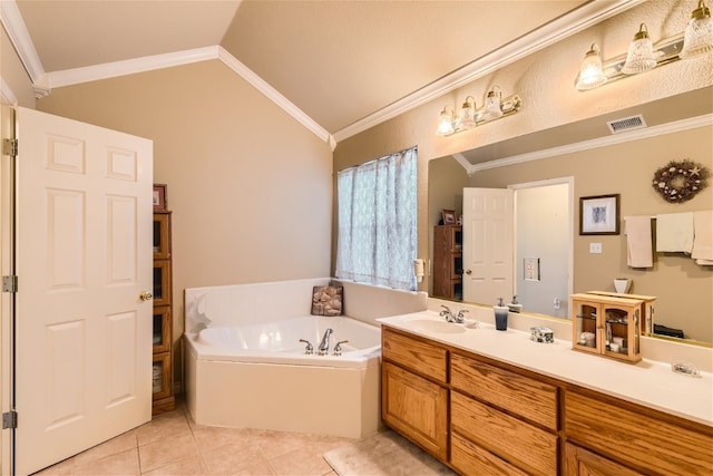 bathroom with vaulted ceiling, vanity, a bathing tub, crown molding, and tile patterned floors