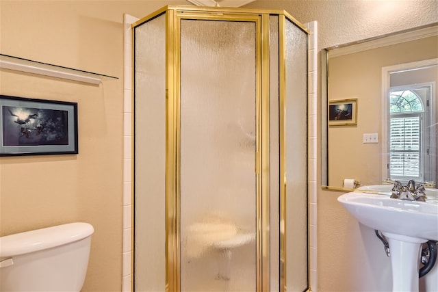 bathroom with an enclosed shower, crown molding, and toilet