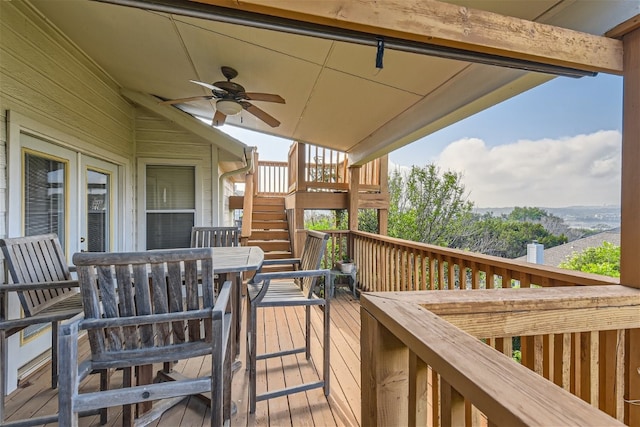 wooden deck featuring ceiling fan