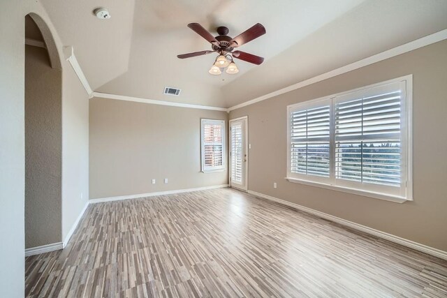 empty room with light wood-type flooring, lofted ceiling, ceiling fan, and ornamental molding