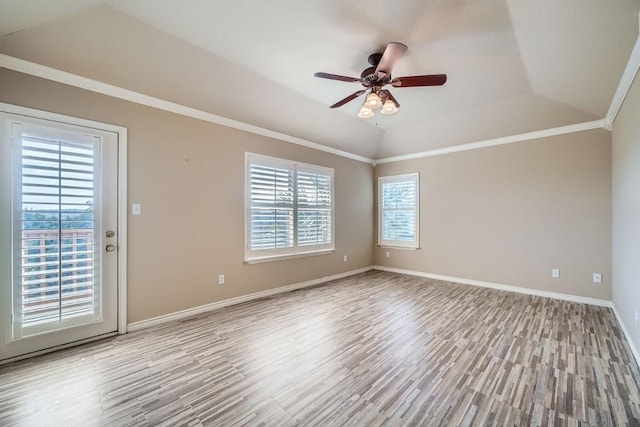 unfurnished room featuring light hardwood / wood-style floors, vaulted ceiling, ceiling fan, and ornamental molding