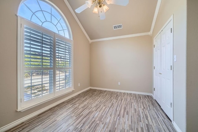 unfurnished bedroom with ceiling fan, light wood-type flooring, crown molding, and multiple windows