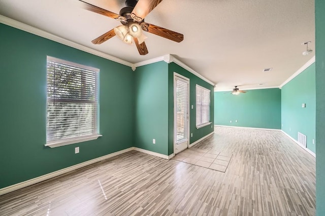 unfurnished room with ornamental molding, ceiling fan, and light hardwood / wood-style flooring