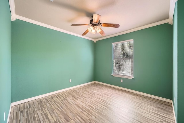 spare room with hardwood / wood-style flooring, ornamental molding, and ceiling fan