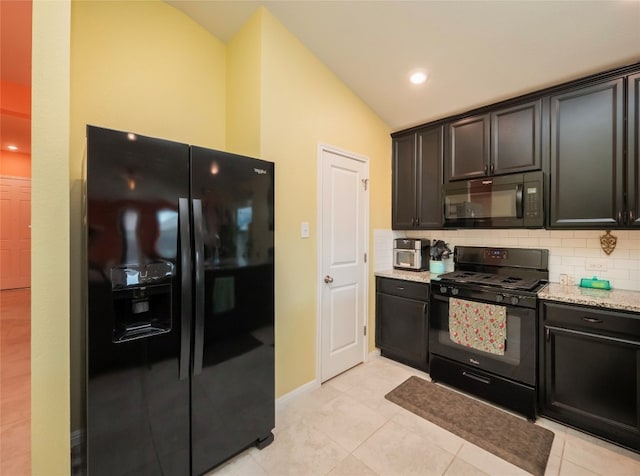 kitchen with light tile patterned floors, black appliances, light stone countertops, vaulted ceiling, and decorative backsplash