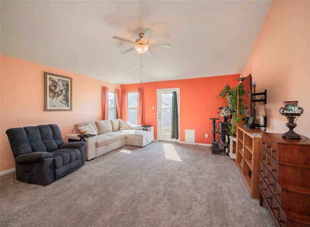 carpeted living room featuring vaulted ceiling and ceiling fan