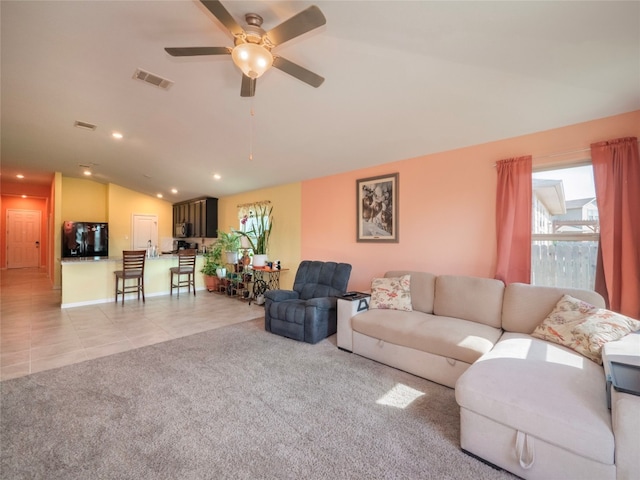 carpeted living room with vaulted ceiling and ceiling fan