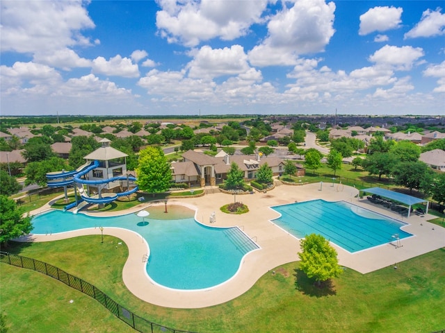 view of pool with a playground, a water slide, a lawn, and a patio area