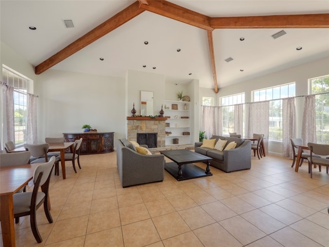 tiled living room with a stone fireplace, beam ceiling, and high vaulted ceiling