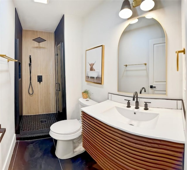 bathroom with tile patterned floors, a shower with door, vanity, and toilet