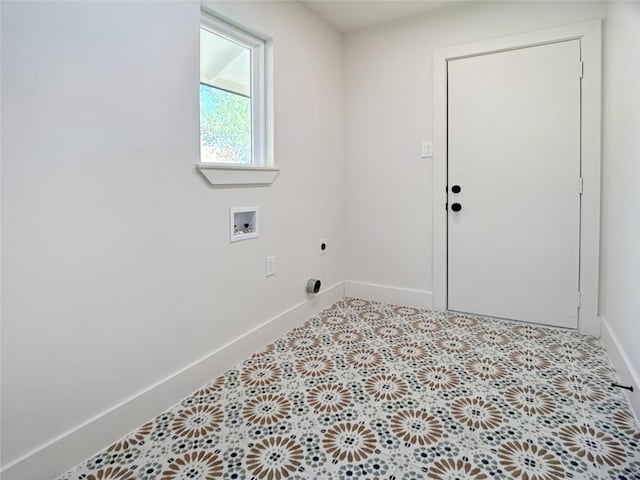 laundry area with hookup for an electric dryer, light tile patterned flooring, and hookup for a washing machine