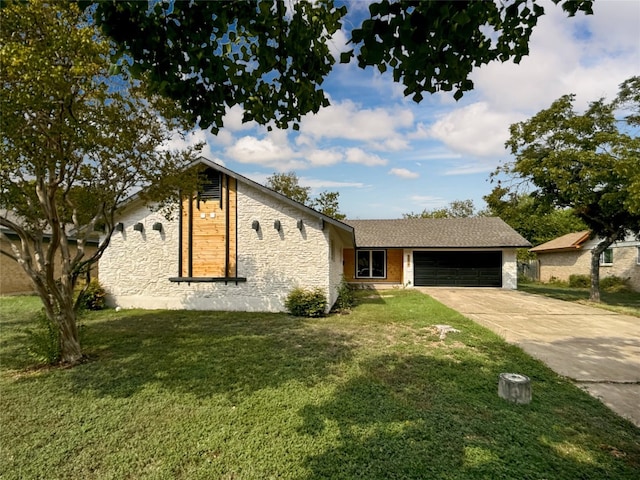 view of front of house with a garage and a front yard