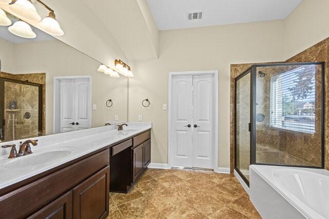 bathroom with vanity and plus walk in shower