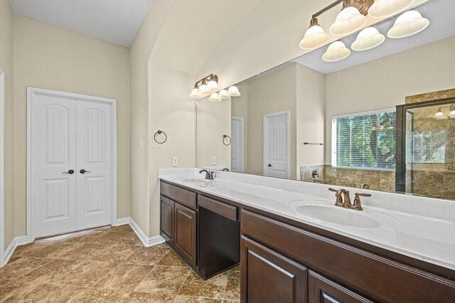 bathroom featuring vanity and a notable chandelier