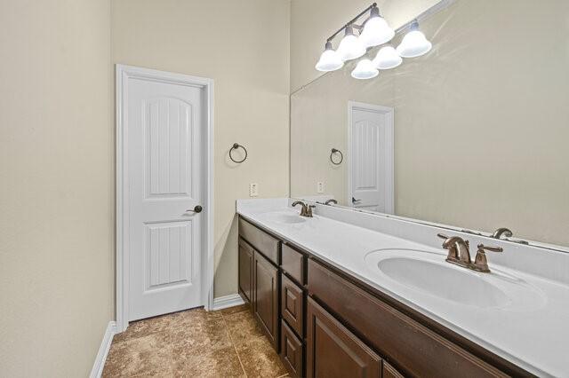 bathroom with vanity and a notable chandelier