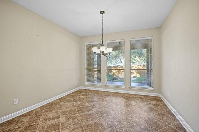 unfurnished dining area with a chandelier