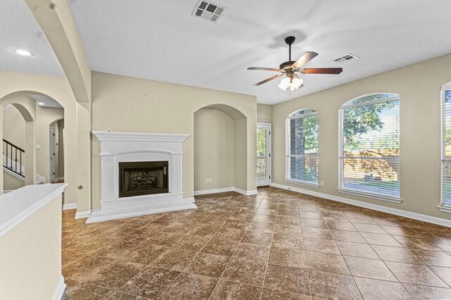 unfurnished living room with ceiling fan