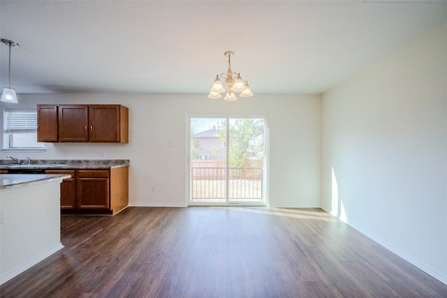 kitchen featuring a chandelier, decorative light fixtures, dark wood-type flooring, and sink