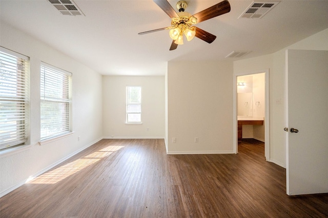 empty room featuring ceiling fan and dark hardwood / wood-style flooring