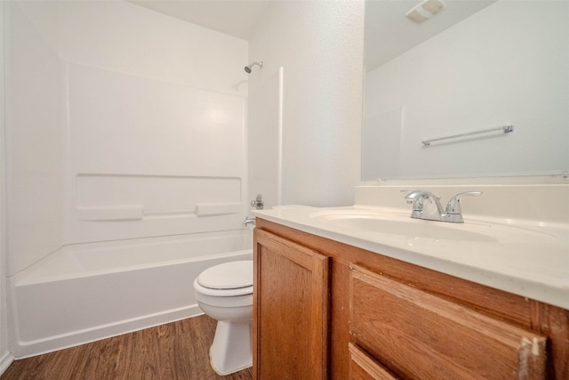 full bathroom featuring  shower combination, vanity, wood-type flooring, and toilet