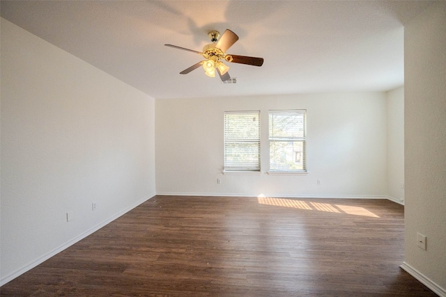 spare room with dark hardwood / wood-style floors and ceiling fan