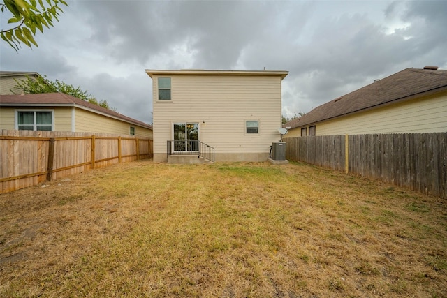 rear view of property with a yard