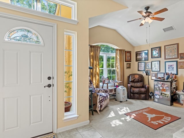 foyer featuring vaulted ceiling, light tile patterned floors, and ceiling fan