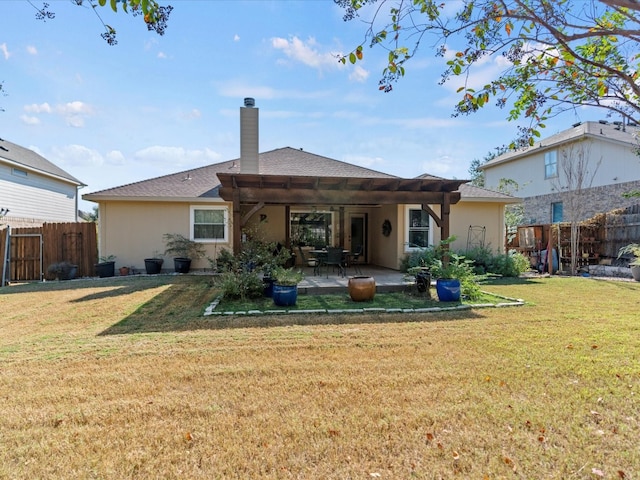 rear view of property featuring a yard and a patio area