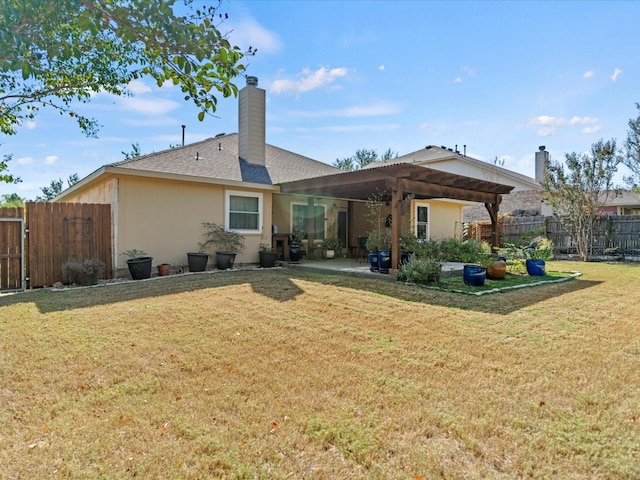 back of house with a patio and a lawn