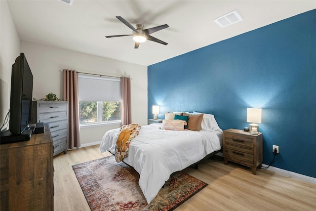 bedroom with light hardwood / wood-style flooring and ceiling fan