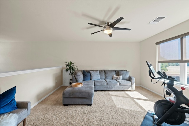 carpeted living room with ceiling fan