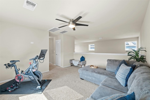 exercise area with ceiling fan and light colored carpet