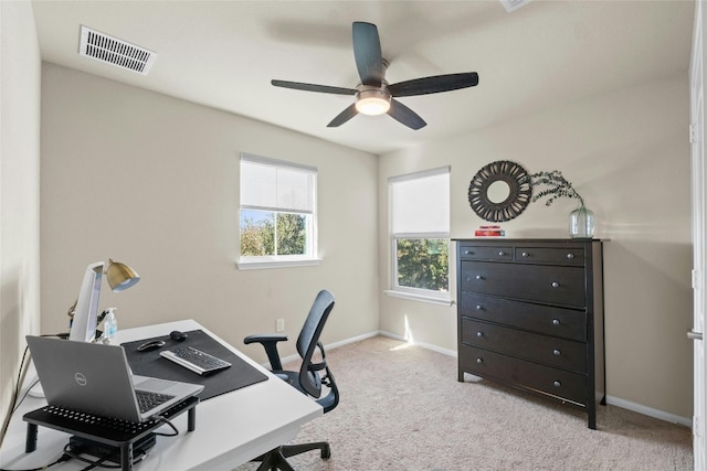 carpeted office space featuring ceiling fan