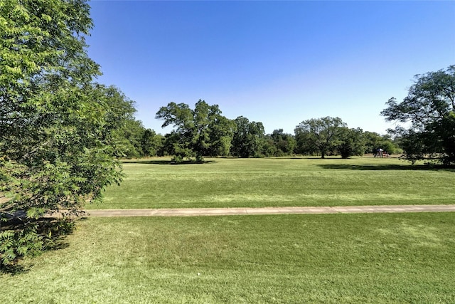 view of property's community with a lawn