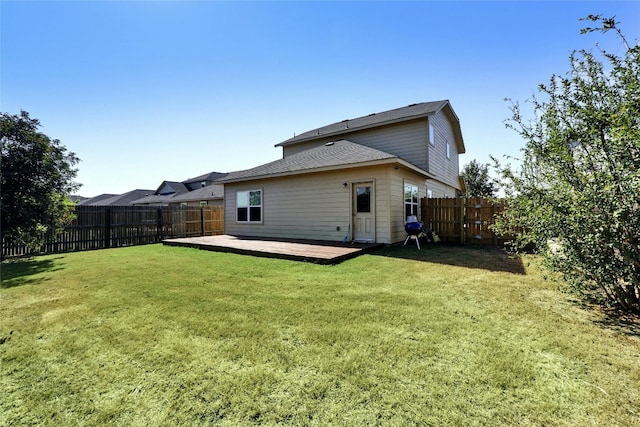 back of house with a yard and a wooden deck