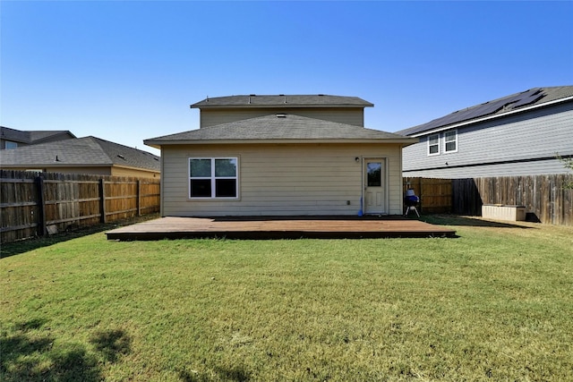 back of property featuring a yard and a deck