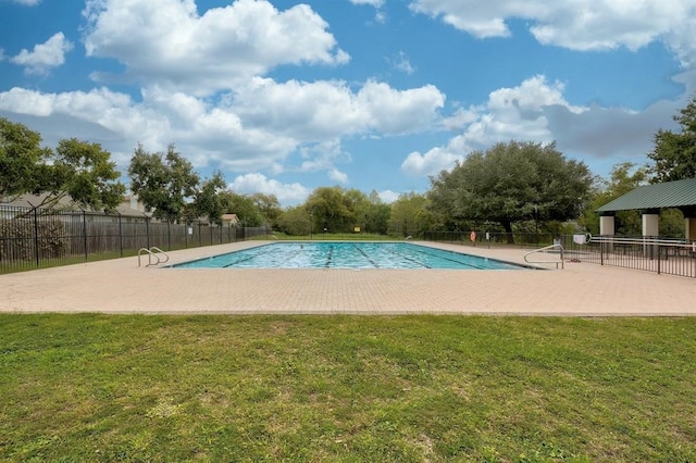 view of pool with a yard and a patio area