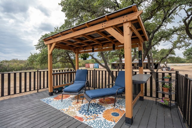 wooden terrace featuring a gazebo